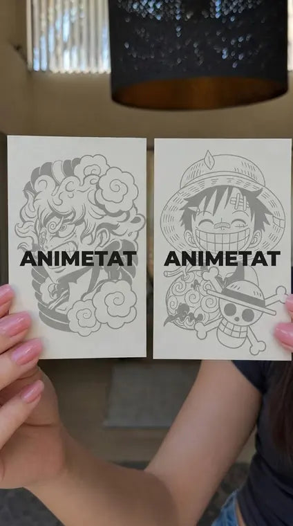 Customer holding ANIMETAT anime tattoo sticker sheets