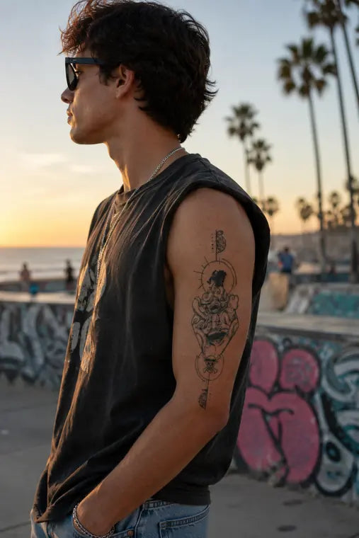 Customer wearing ANIMETAT tattoo on upper arm outdoors