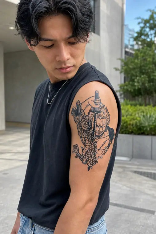Customer wearing detailed ANIMETAT anime tattoo on upper arm